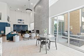 A modern living room with a dining table and chairs at The Preserve at Preston Trails Apartments, Cedar Hill, Texas