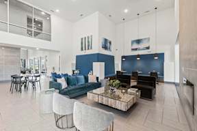 A modern living room with a blue accent wall and a coffee table in the center at The Preserve at Preston Trails Apartments, Cedar Hill, TX, 75104
