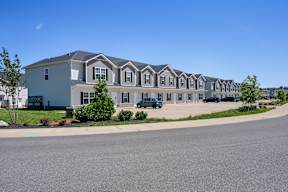A long row of houses with cars parked in front at Arrowood Farms, Clarksville