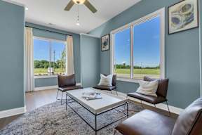 A living room with a brown leather chair and a white coffee table.at Arrowood Farms, Clarksville Tennessee