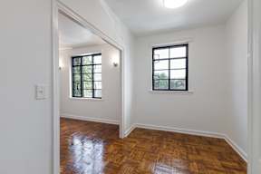 Spacious bedroom with newly renovated flooring  and large windows  at Marleigh apartments located in Indianapolis, IN