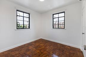 A room with two windows and wooden flooring  at Marleigh apartments located in Indianapolis, IN