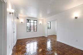 Spacious bedroom with wooden floors and two windows  at Marleigh apartments located in Indianapolis, IN