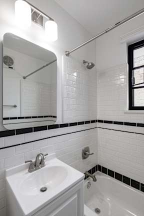 Newly renovated bathroom with bathtub, sink and toilet  at Marleigh apartments located in Indianapolis, IN
