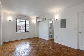 A room with a window and a door.