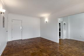 A room with wooden floors and white walls.