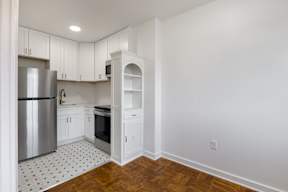 Newly renovated kitchen with stainless steal appliances, new countertops and a black and white flooring  at Marleigh apartments located in Indianapolis, IN