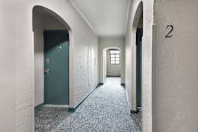 Spacious hallways with window and painted doors at Marleigh apartments located in Indianapolis, IN