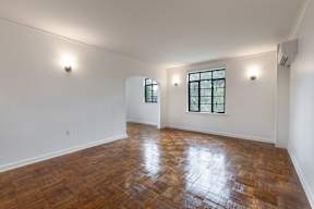 A room with a wooden floor and a window.