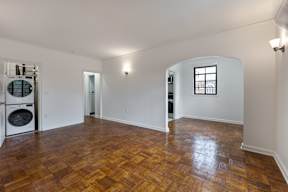 A room with wooden flooring and a window.