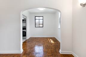 A room with a wooden floor and a window.