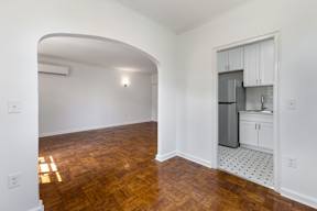 Spacious living room with wooden flooring and windows  at Marleigh apartments located in Indianapolis, IN