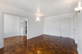 A room with wooden floors and white walls with crown molding  at Marleigh apartments located in Indianapolis, IN