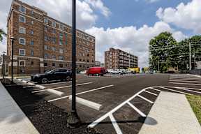 A parking lot with uncovered parking for tenants  at Marleigh apartments located in Indianapolis, IN