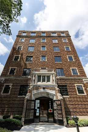 A tall brick apartment building with heating and crown molding  at Marleigh apartments located in Indianapolis, IN