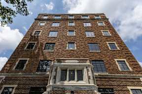A tall brick apartment building crown molding, at Marleigh apartments located in Indianapolis, IN