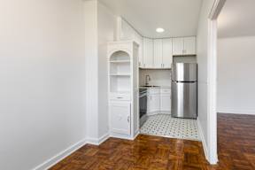 Newly renovate kitchen with white cabinets, wooden floor, stainless steal appliances, and new countertops  at Marleigh apartments located in Indianapolis, IN