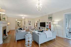 A living room with a grey couch and a white coffee table.
