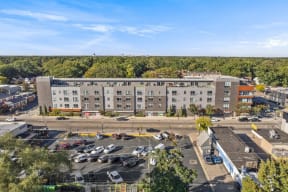 an aerial view of an apartment complex with a parking lot