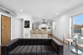 a living room with a couch and a kitchen in the background