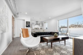 a living room with a couch and a chair and a table