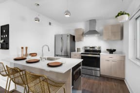 a kitchen with stainless steel appliances and a marble counter top