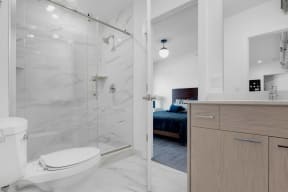 a bathroom with a shower and a bed