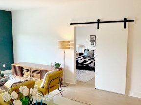 a living room with a sliding door to a bedroom