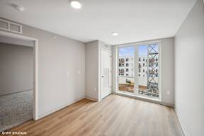 Harbourline Apartments, St Paul an empty living room with a large window and wood flooring