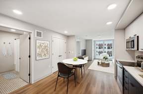 Harbourline Apartments, St Paul an open kitchen and living room with a table and chairs