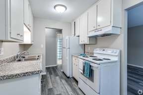 A kitchen with white appliances and cabinets.