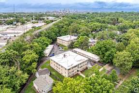 A large building surrounded by trees is the main focus of this image.