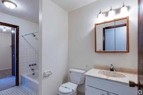 A white toilet with a blue label on it is in a bathroom.