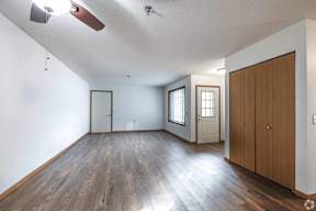 A room with wooden floors and white walls.