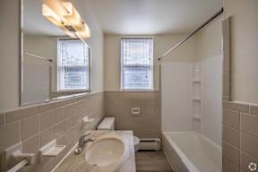 A bathroom with a sink, toilet, and bathtub.