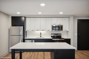 Harbourline Apartments, St Paul a kitchen with white cabinets and stainless steel appliances