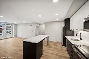 Harbourline Apartments, St Paul a renovated kitchen with white cabinets and a white counter top