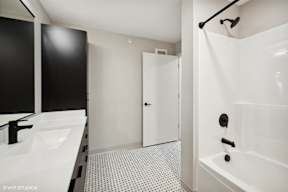 Harbourline Apartments, St Paul a bathroom with a shower and a sink and a mirror