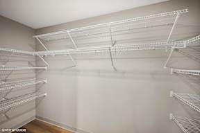 Harbourline Apartments, St Paul the spacious walk in closet in the master bedroom has shelves and wire shelving