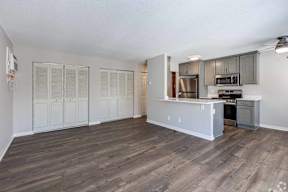 A kitchen with a refrigerator, oven, and microwave.