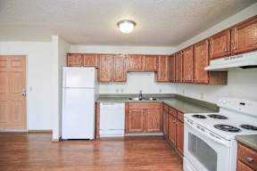 A kitchen with wooden cabinets and white appliances.
