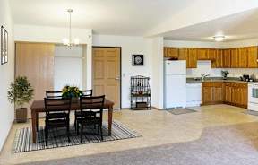 A dining room with a table set for two.