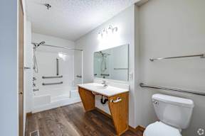 A white toilet sits next to a sink in a bathroom.