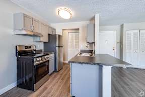 A kitchen with a black oven and stove top.