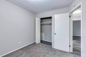 A white door is open in a room with a carpeted floor.
