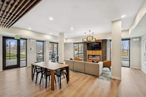 Wangstad Commons, Brooklyn Center,  A modern dining room with a wooden table and chairs.
