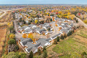 A bird's eye view of a residential area with houses and trees.