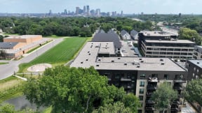 an aerial view of the building with the city skyline in the background