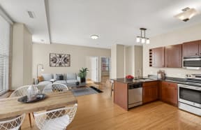 a living room and kitchen with a couch and a table