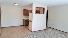 A room with a small kitchenette and a window.